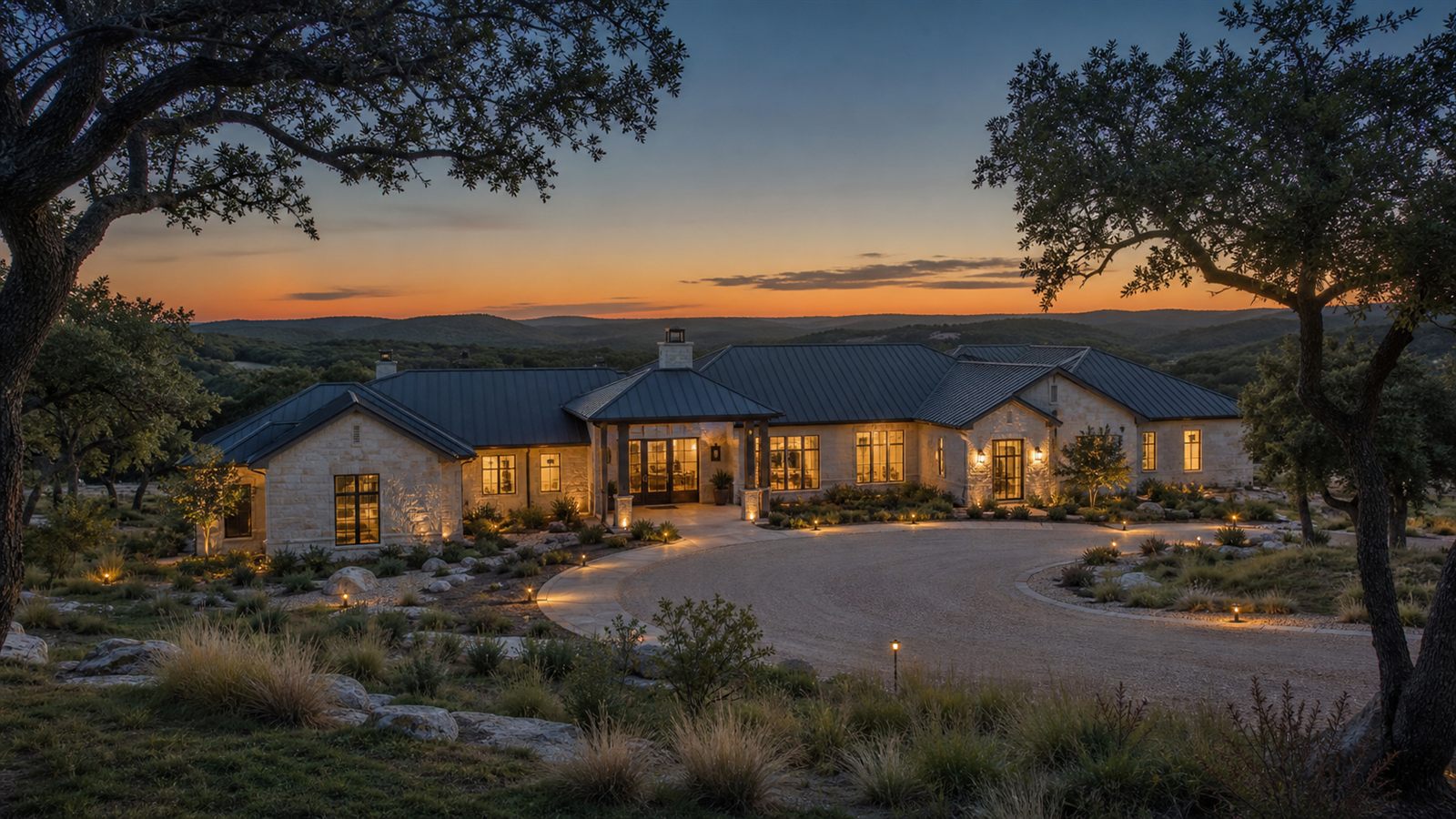 Limestone and wood custom home at golden hour in the Texas Hill Country near Spicewood