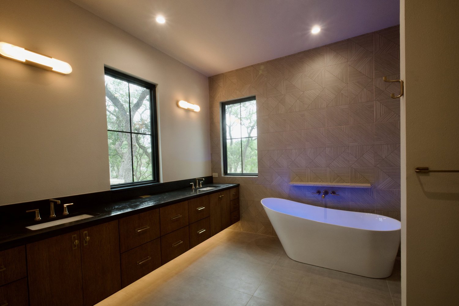 Primary bath vanity in white oak with Broadway Black Leathered quartz