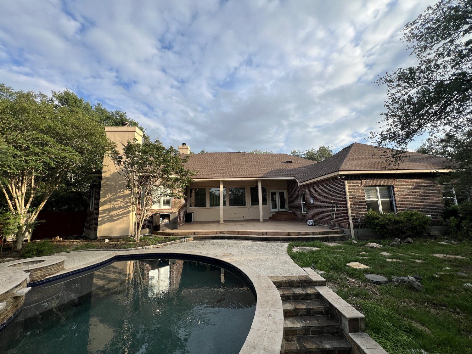 San Marcos project before the rebuild: original brick rear elevation and dated pool deck